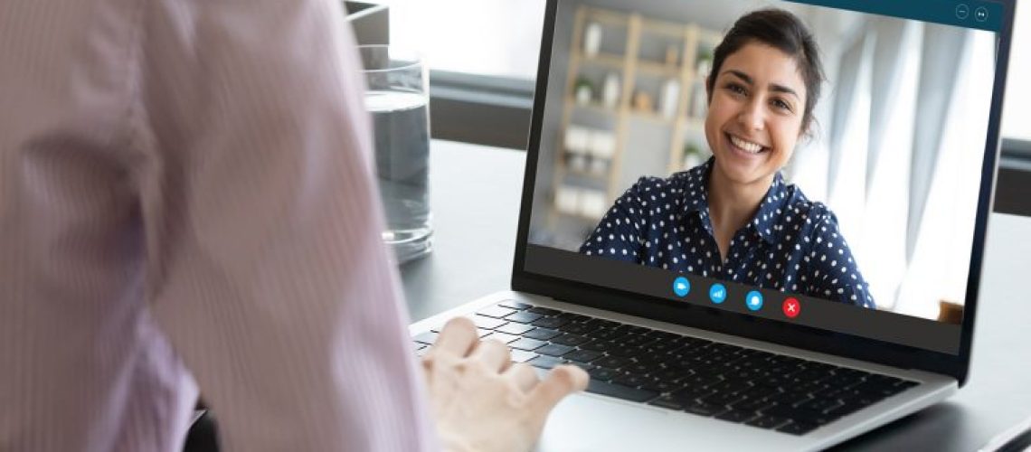 young-woman-smiling-in-video-call-window-on-laptop-display-768